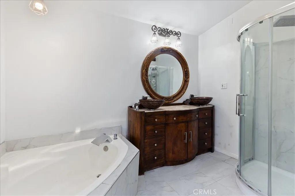 9080 Bloomfield Avenue, Unit 237 Cypress, CA 90630 - Photo 11 of 24 a bathroom with a sink a mirror and a bathtub