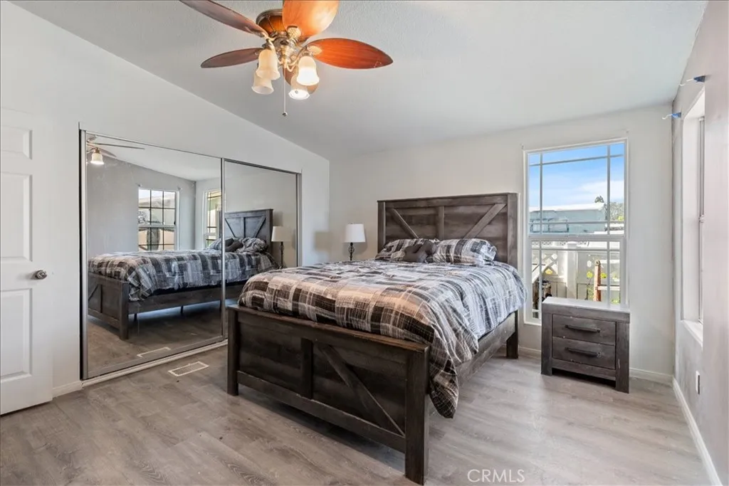 9080 Bloomfield Avenue, Unit 237 Cypress, CA 90630 - Photo 12 of 24 a bedroom with a bed and a chandelier