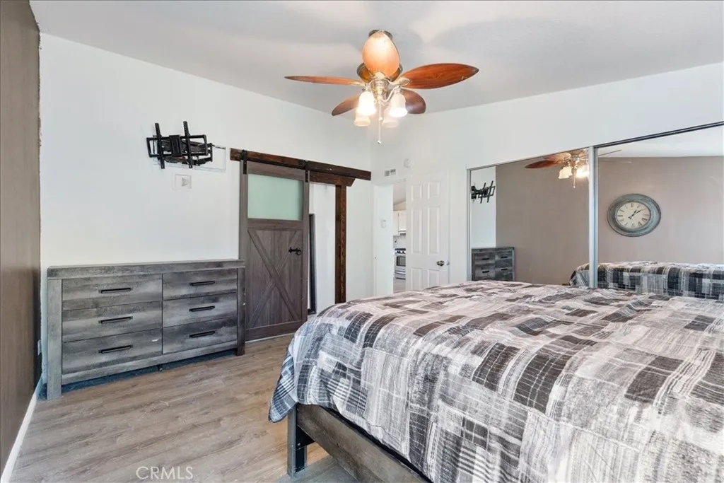 9080 Bloomfield Avenue, Unit 237 Cypress, CA 90630 - Photo 14 of 24 a bedroom with a bed and a chandelier