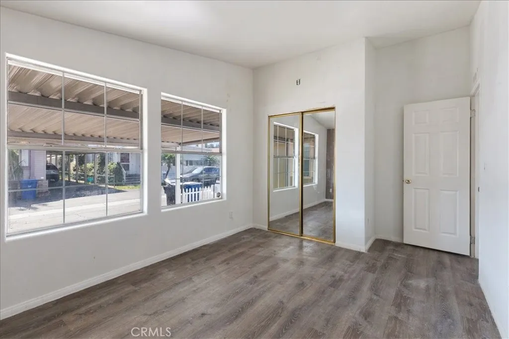 9080 Bloomfield Avenue, Unit 237 Cypress, CA 90630 - Photo 18 of 24 an empty room with wooden floor and windows