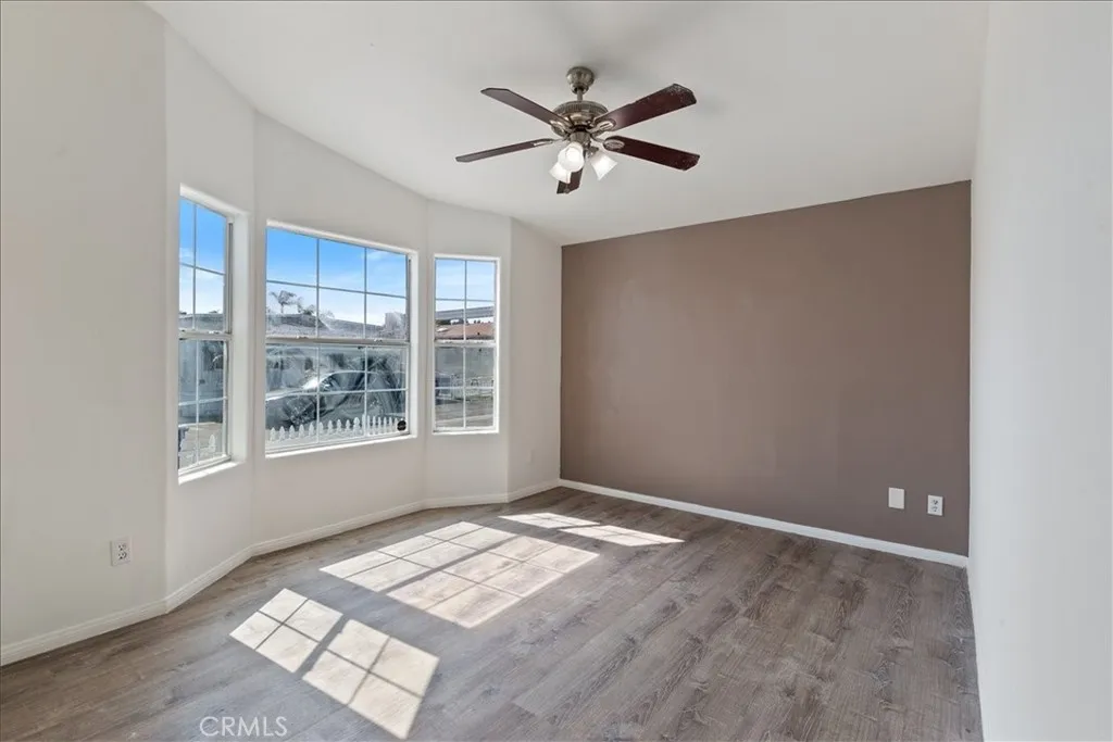 9080 Bloomfield Avenue, Unit 237 Cypress, CA 90630 - Photo 20 of 24 a view of empty room with wooden floor and fan