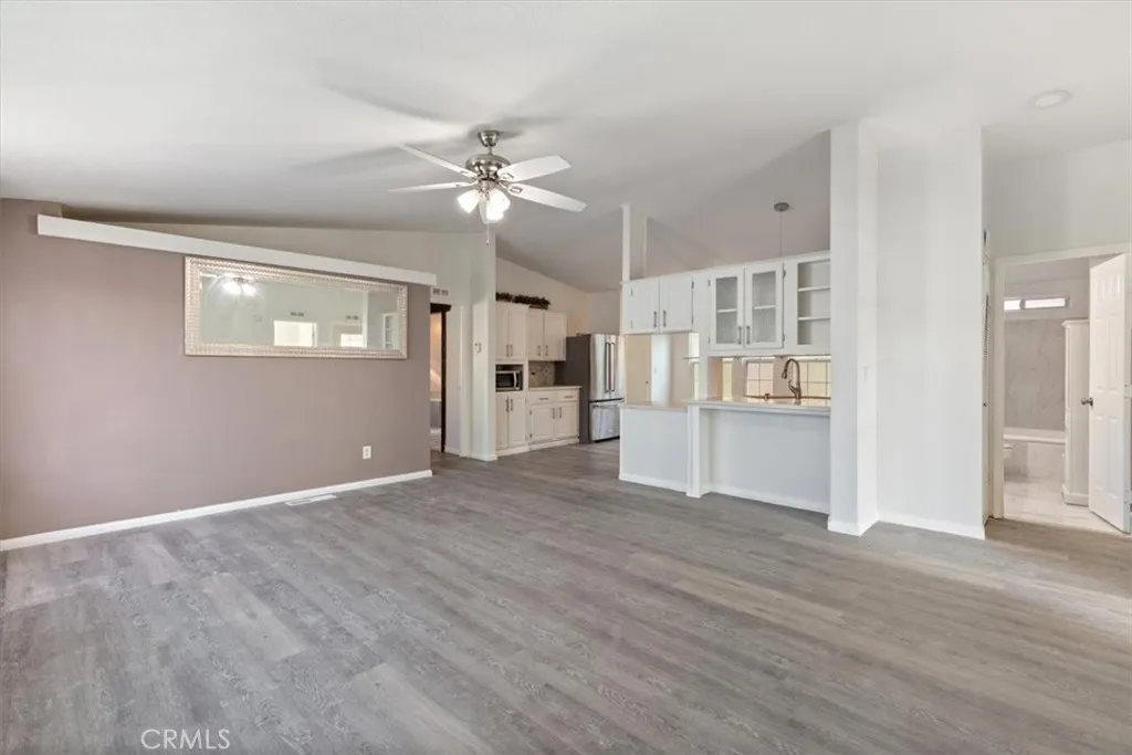 9080 Bloomfield Avenue, Unit 237 Cypress, CA 90630 - Photo 9 of 24 a view of a kitchen with wooden cabinet and a ceiling fan