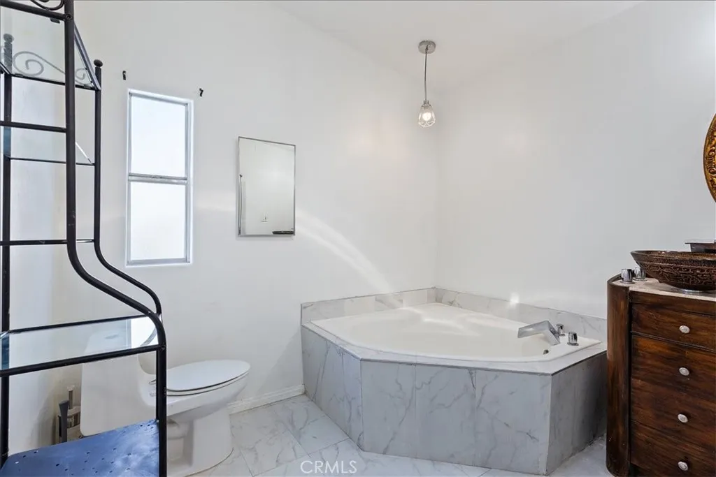 9080 Bloomfield Avenue, Unit 237 Cypress, CA 90630 - Photo 10 of 24 a bathroom with a bathtub and a shower