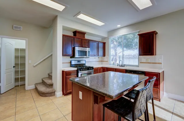 a kitchen with a stove a sink and a refrigerator