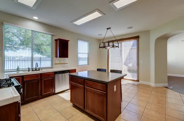 a kitchen with a sink stove and cabinets