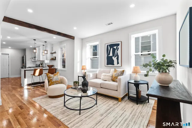 a living room with furniture and a table