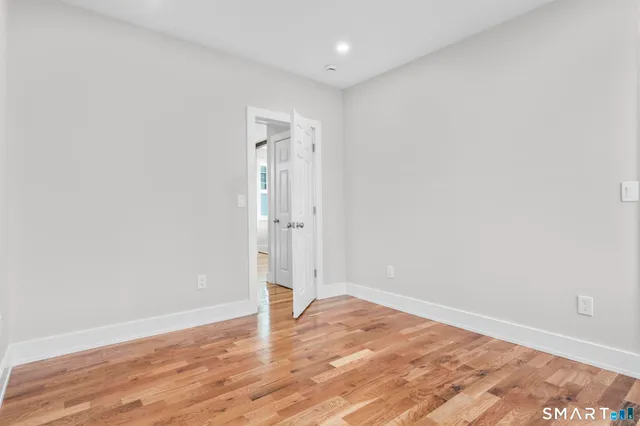 an empty room with wooden floor
