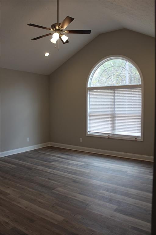 27 Parkman Road Phenix City, AL 36869 - Photo 10 of 11 Spare room featuring dark wood finished floors, recessed lighting, baseboards, ceiling fan, and vaulted ceiling