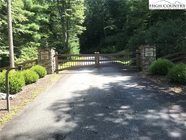 a view of a fence yard and green space