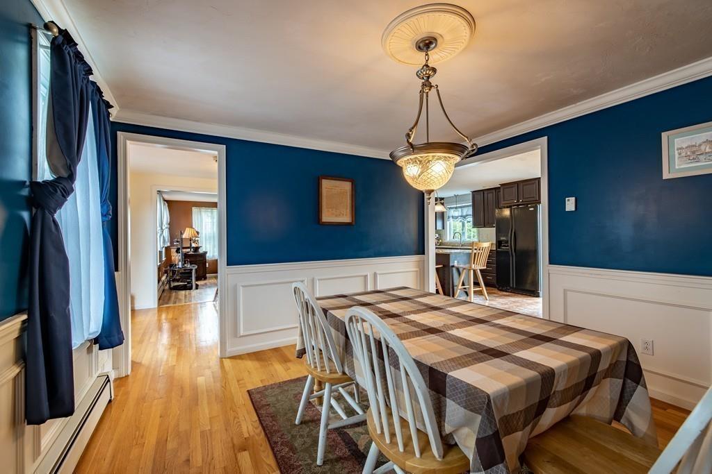 6 Carley Circle Rutland, MA 01543 - Photo 15 of 39 a dining room with wooden floor furniture and a chandelier