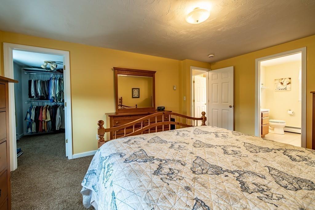 6 Carley Circle Rutland, MA 01543 - Photo 26 of 39 a bedroom with a bed and a large mirror in it