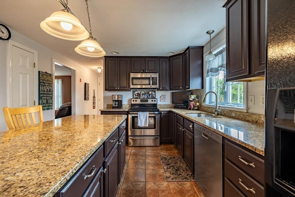 6 Carley Circle Rutland, MA 01543 - Photo 8 of 39 a kitchen with stainless steel appliances granite countertop sink stove top oven and cabinets