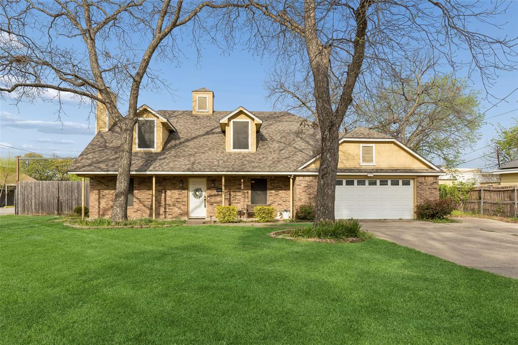 a front view of house with yard and green space