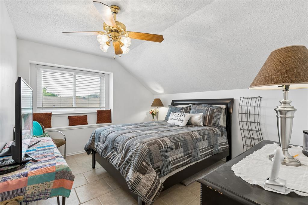 1317 Trinity View Street Irving, TX 75060 - Photo 17 of 31 a bedroom with a bed and a chandelier