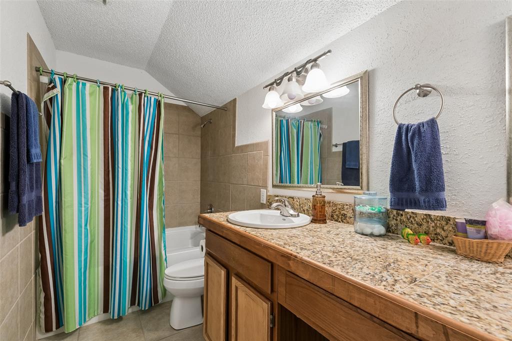 1317 Trinity View Street Irving, TX 75060 - Photo 18 of 31 a bathroom with a granite countertop sink and a mirror