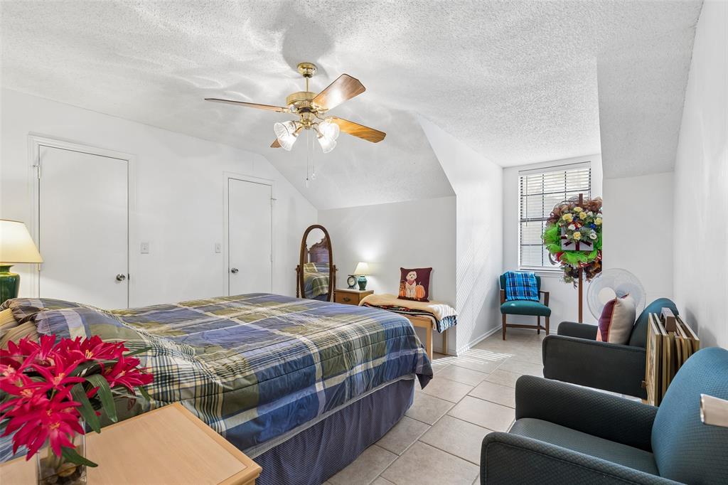 1317 Trinity View Street Irving, TX 75060 - Photo 19 of 31 a bedroom with a bed couch and a ceiling fan