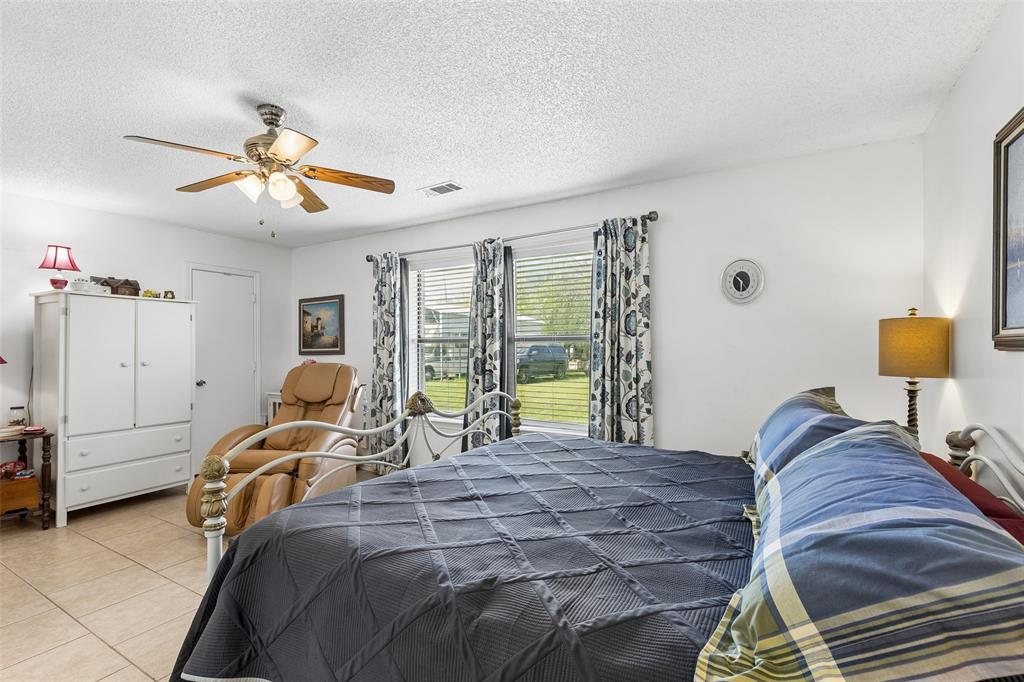 1317 Trinity View Street Irving, TX 75060 - Photo 23 of 31 a bedroom with a bed and a chandelier