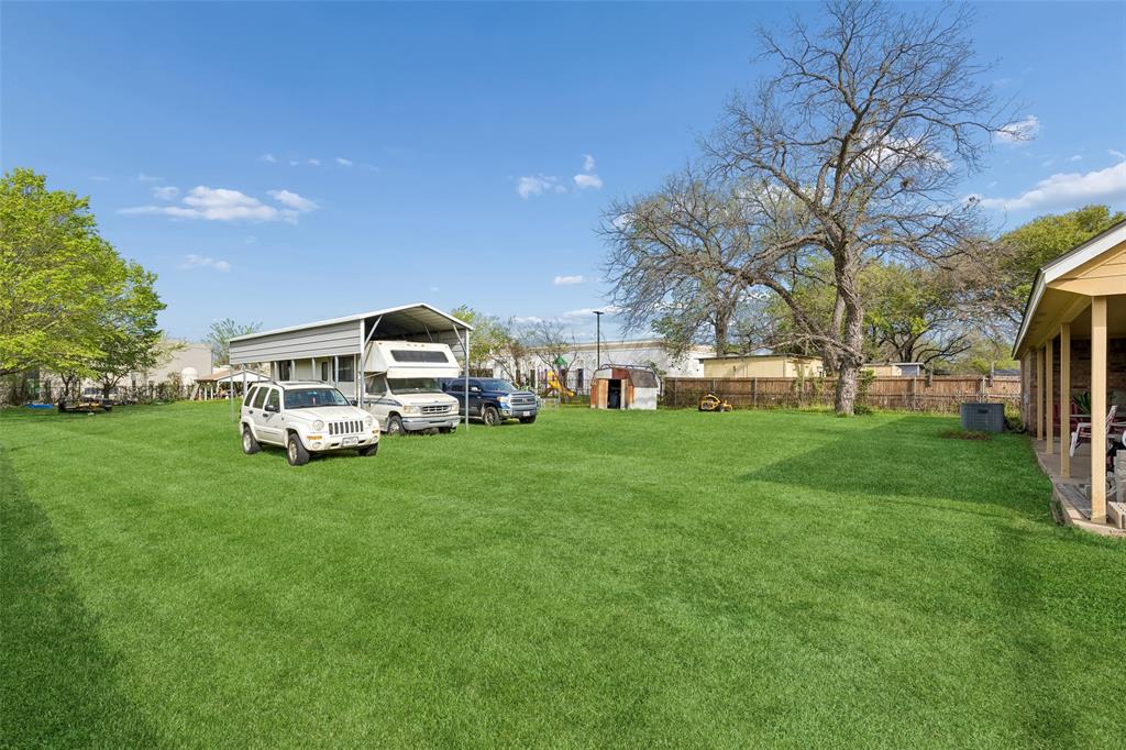 1317 Trinity View Street Irving, TX 75060 - Photo 28 of 31 a white house with a big yard and large trees