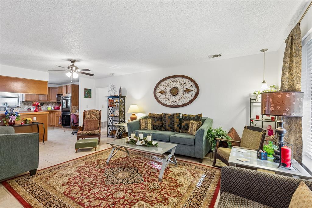 1317 Trinity View Street Irving, TX 75060 - Photo 3 of 31 a living room with furniture a rug and white walls
