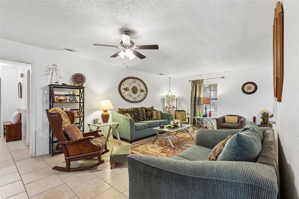 1317 Trinity View Street Irving, TX 75060 - Photo 4 of 31 a living room with furniture and a clock