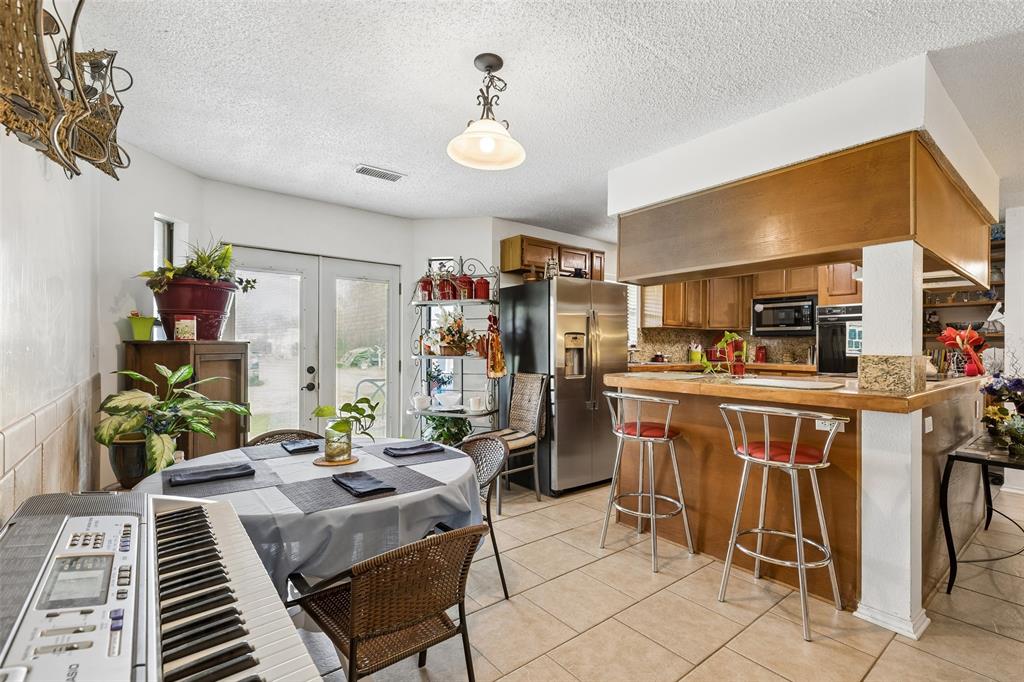 1317 Trinity View Street Irving, TX 75060 - Photo 7 of 31 a view of a dining room with furniture window and outdoor kitchen