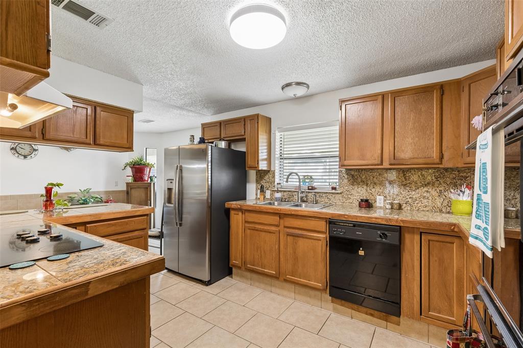1317 Trinity View Street Irving, TX 75060 - Photo 8 of 31 a kitchen with stainless steel appliances granite countertop a sink stove and refrigerator