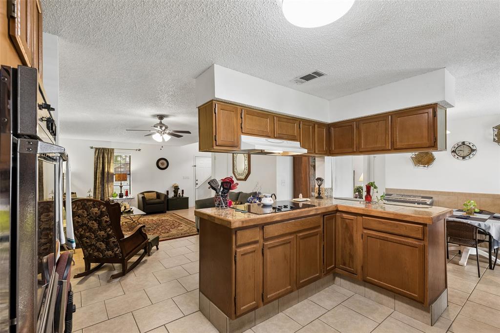 1317 Trinity View Street Irving, TX 75060 - Photo 9 of 31 a kitchen with a sink a stove and cabinets