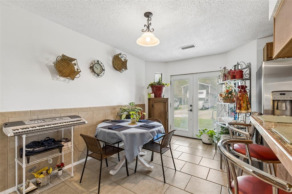 1317 Trinity View Street Irving, TX 75060 - Photo 10 of 31 a view of a dining room with furniture and chandelier