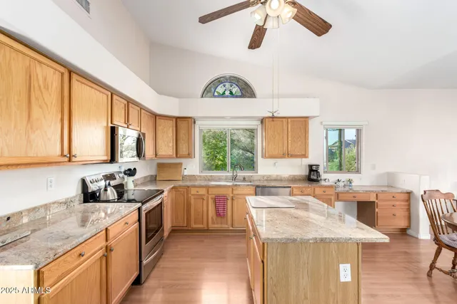 a kitchen with stainless steel appliances granite countertop a sink stove and cabinets