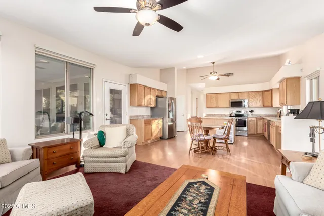 a living room with furniture and a view of kitchen