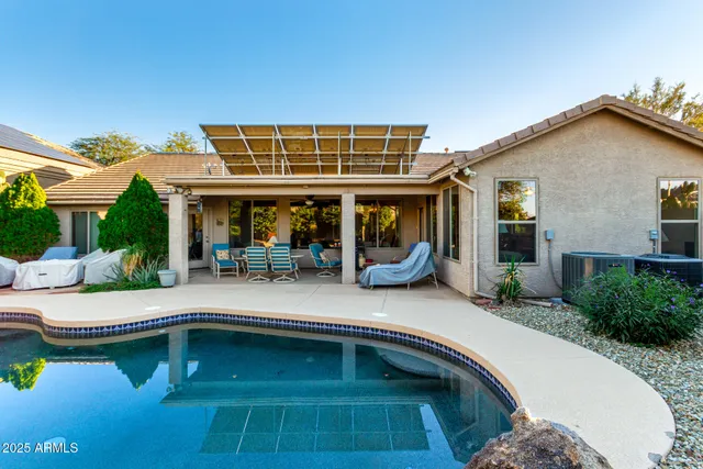 a view of a house with pool porch and sitting area