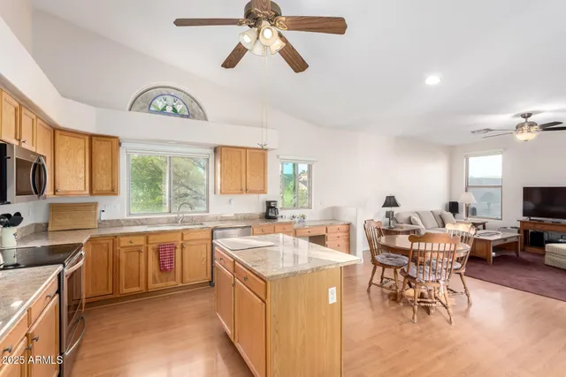 a open kitchen with stainless steel appliances granite countertop a sink and a stove