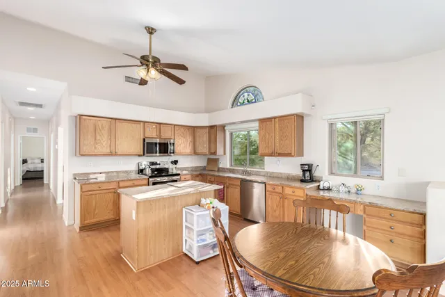 a kitchen with a stove a sink a dining table and chairs