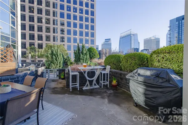 a view of a patio with table and chairs and potted plants