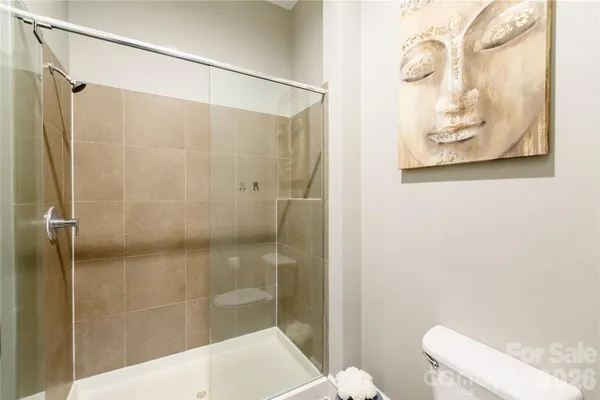 a bathroom with a shower and toilet