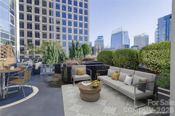 a view of a patio with couches and a potted plant