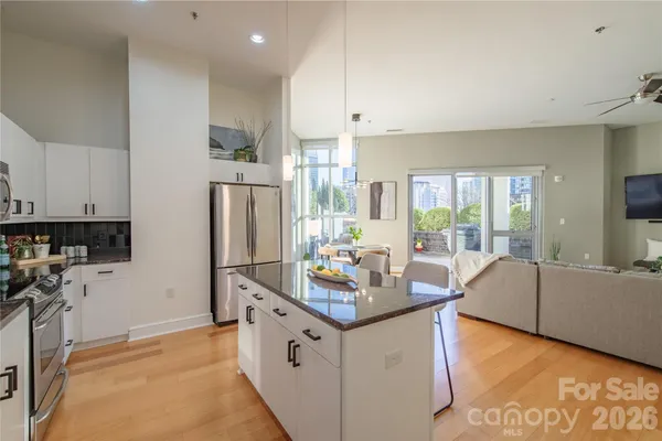 a kitchen with granite countertop a sink stove and refrigerator