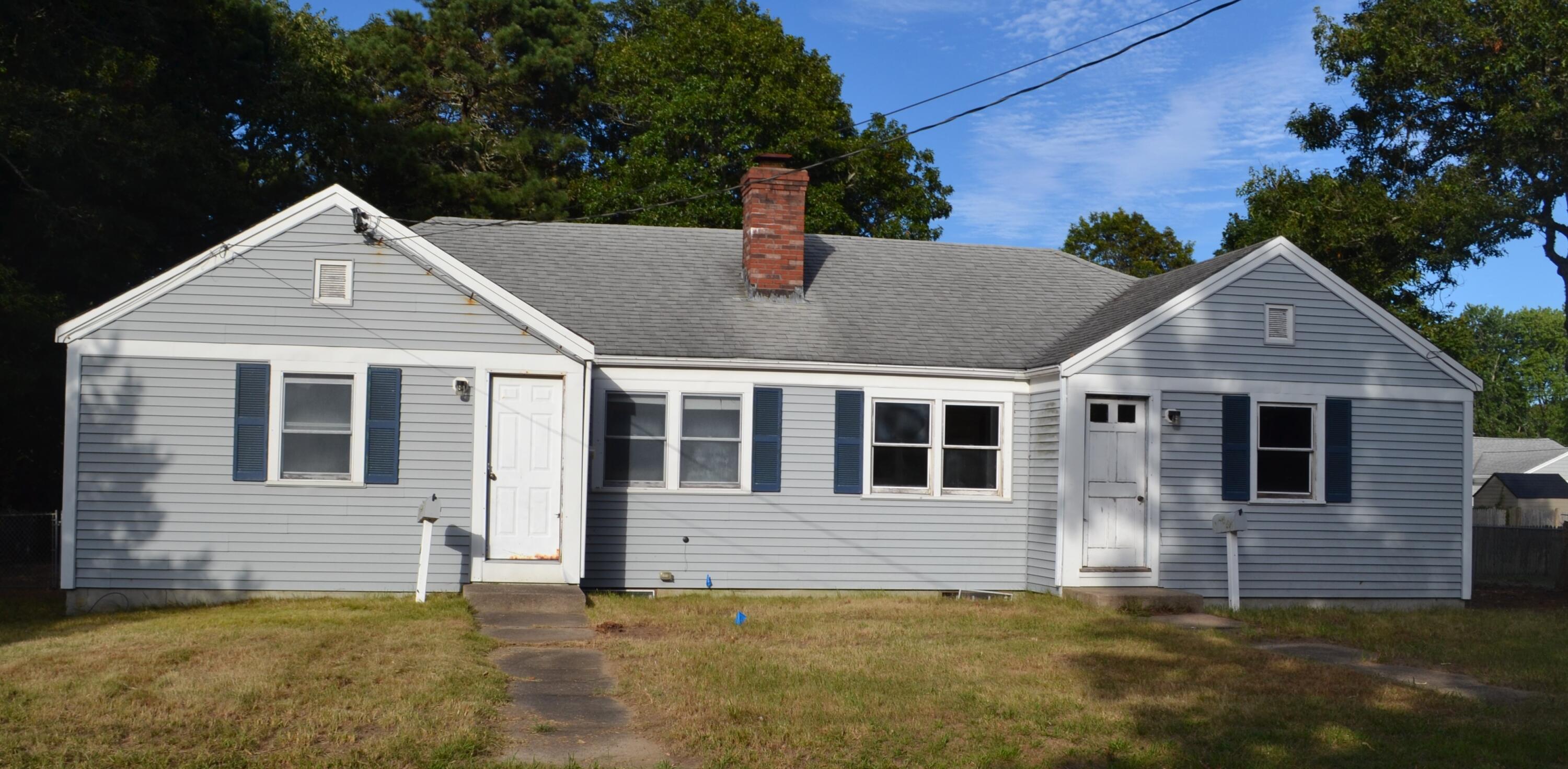 a front view of a house with a garden