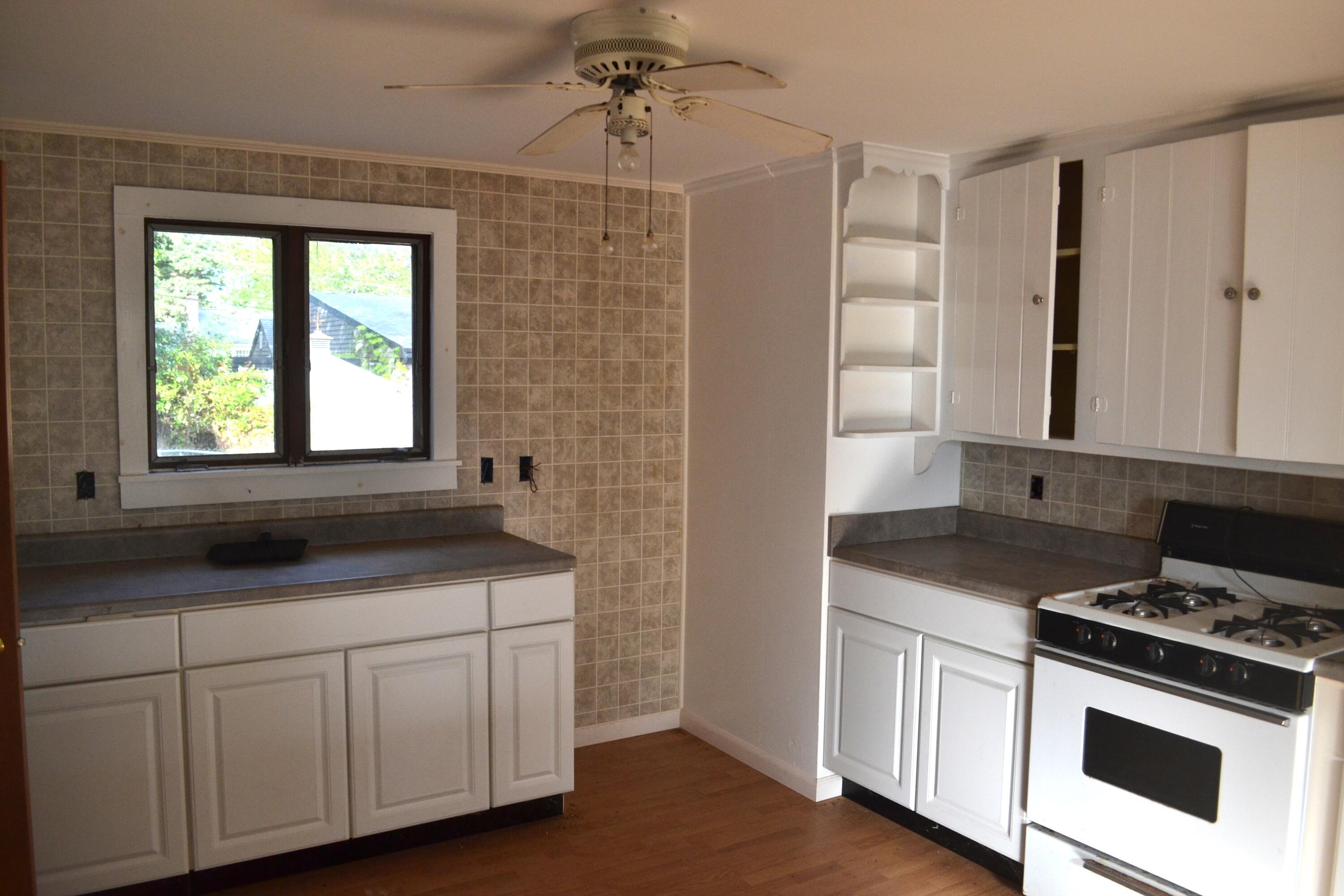 26-28 Hudson Road West Yarmouth, MA 02673 - Photo 7 of 10 a kitchen with a stove and a sink