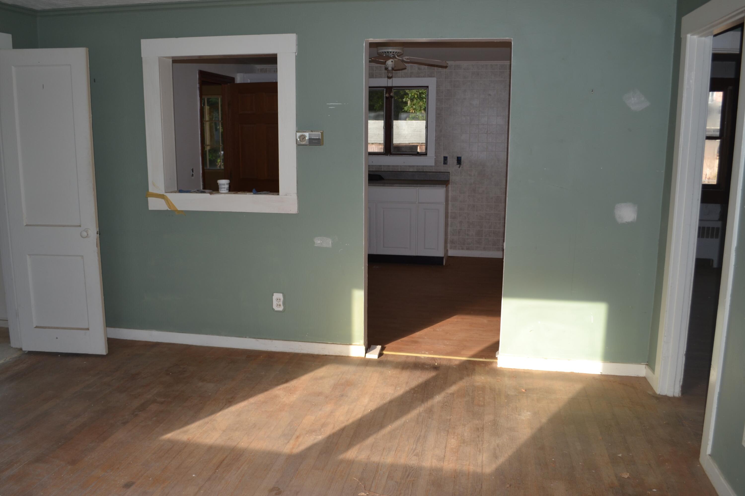 26-28 Hudson Road West Yarmouth, MA 02673 - Photo 8 of 10 a view of a hallway with wooden floor and a cabinet