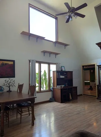 a view of a workspace with furniture and a window