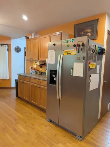 a utility room with refrigerator and washer