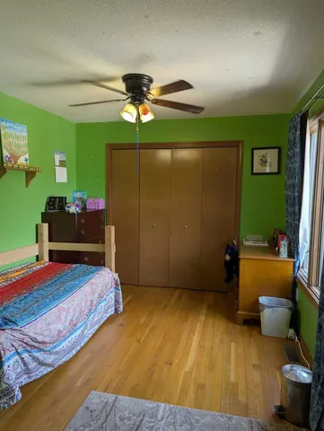 a bedroom with a bed and a bookshelf