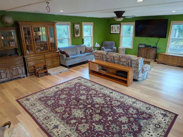 a living room with furniture rug and window