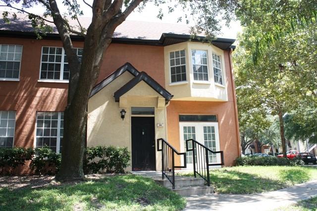 6328 Raleigh Street, Unit 811 Orlando, FL 32835 - Photo 1 of 1 front view of house with a yard