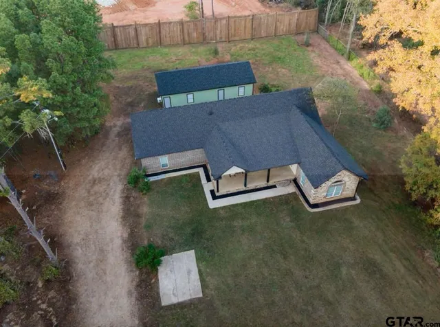 an aerial view of a house with a yard