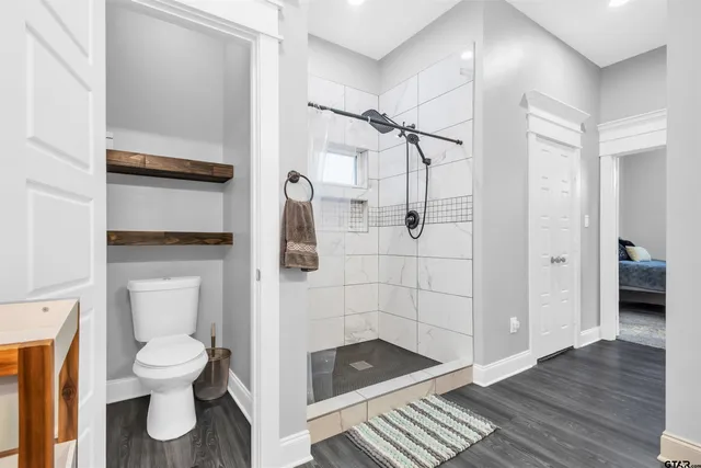 a bathroom with a toilet and a shower