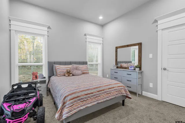 a bedroom with a bed and a dresser in it