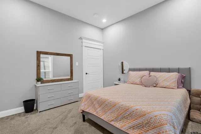 a bedroom with a bed and cabinet