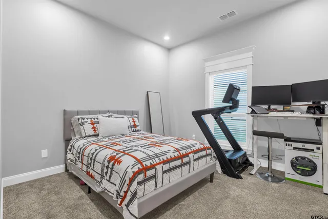 a bedroom with a bed a table and a fireplace